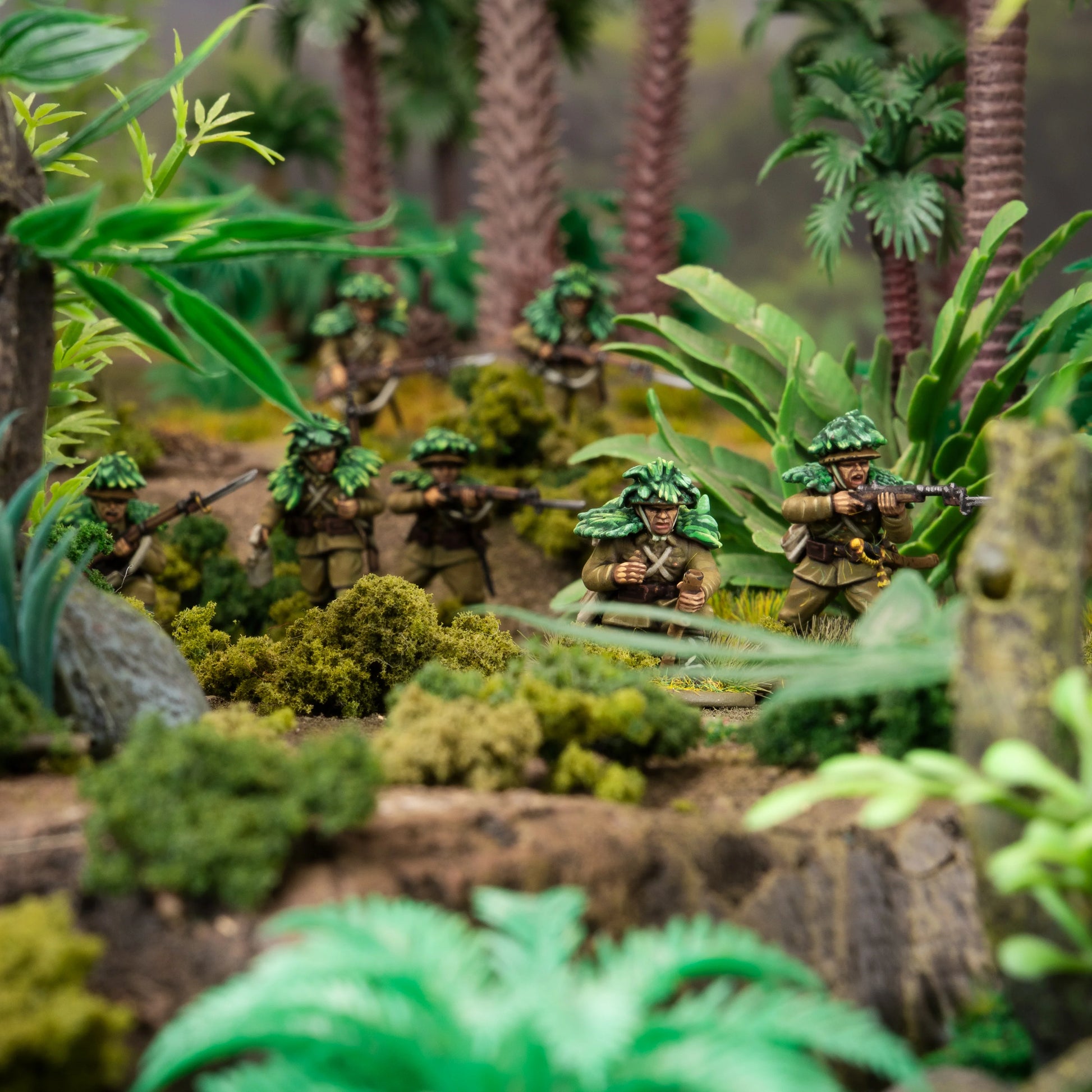 Model soldiers in a jungle setting with greenery and trees.