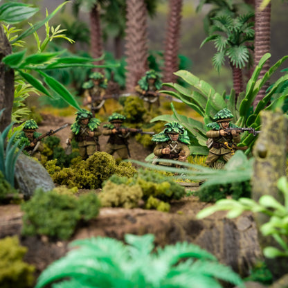 Model soldiers in a jungle setting with greenery and trees.